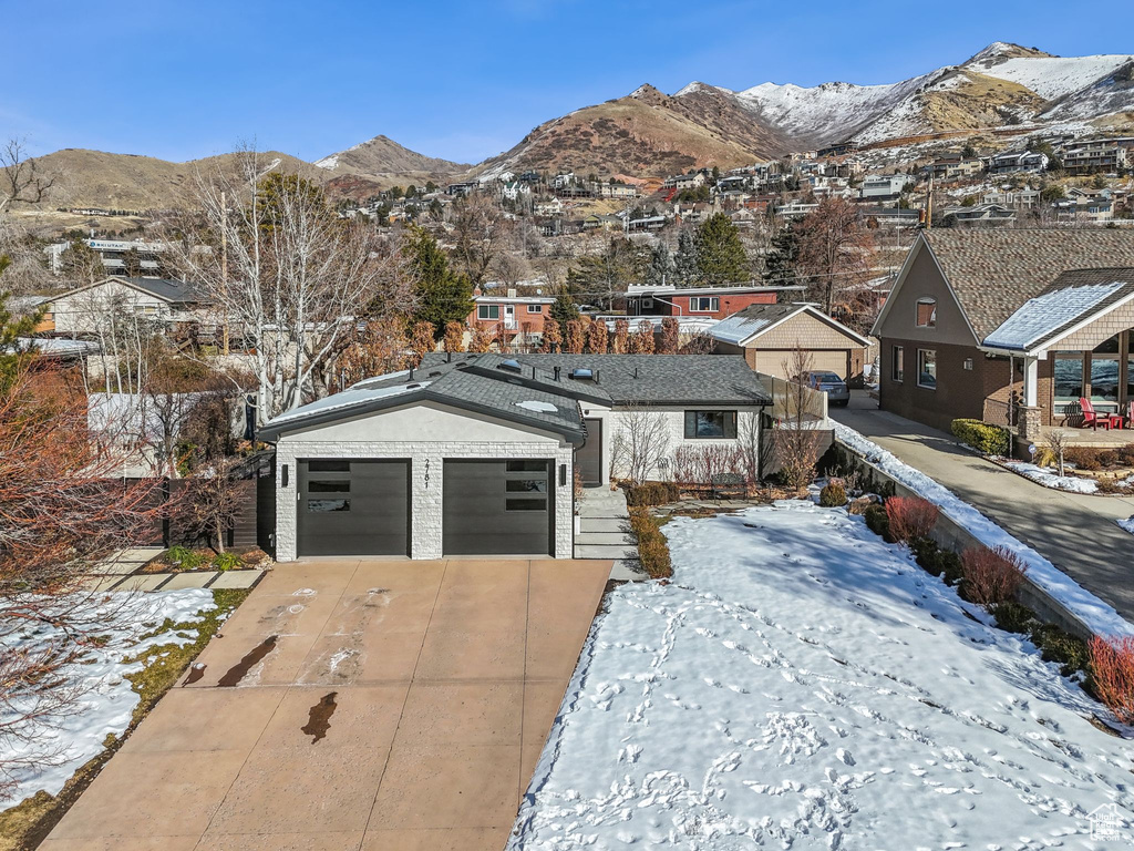 View of front facade with a mountain view and a garage