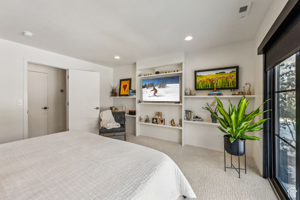 Bedroom featuring light carpet