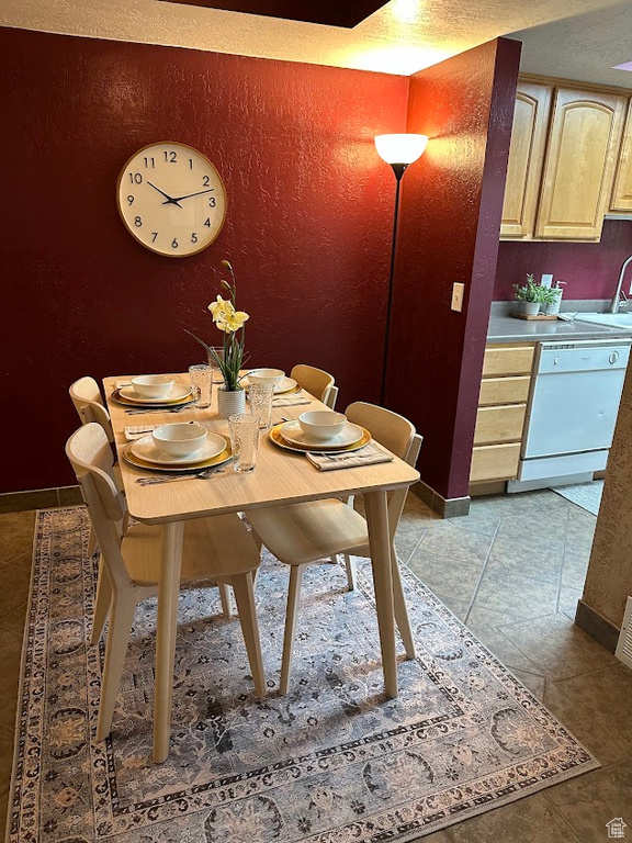 Dining area with baseboards and stone finish flooring