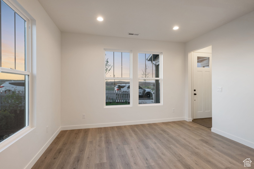Empty room featuring wood finished floors, recessed lighting, and baseboards