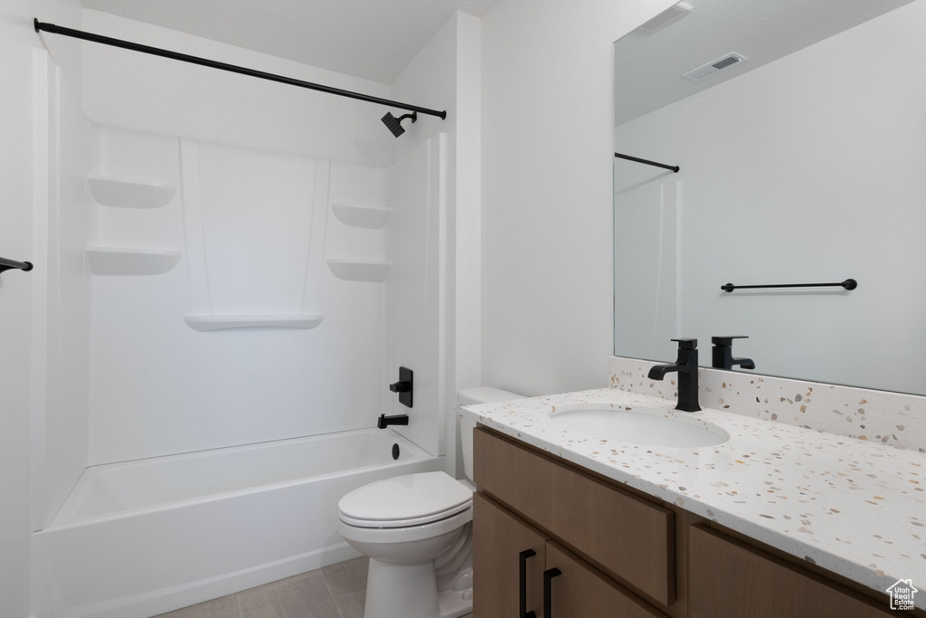 Bathroom with vanity, toilet, tub / shower combination, and tile patterned flooring
