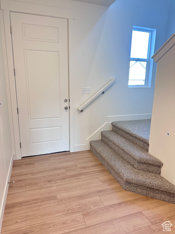 Staircase featuring hardwood / wood-style floors