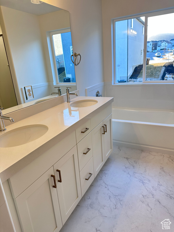 Bathroom featuring vanity and a bathtub
