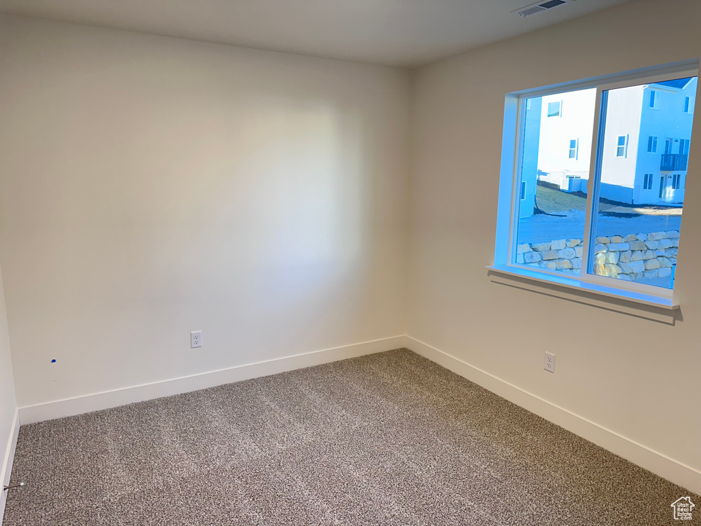 Unfurnished room featuring carpet flooring