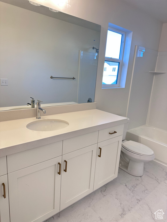 Full bathroom featuring vanity, toilet, and shower / bath combination