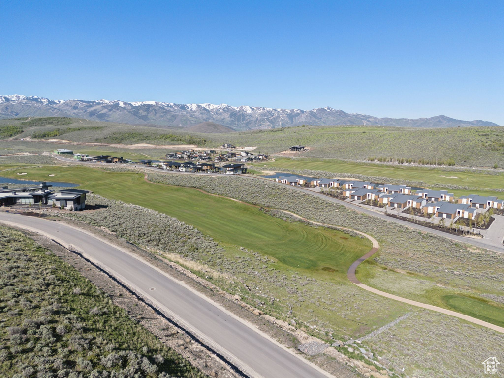 Aerial view of a mountainous background and a golf course