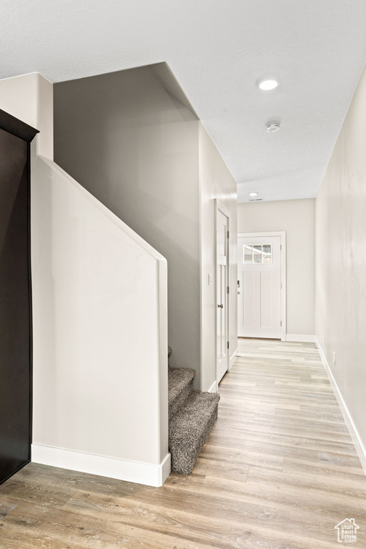 Corridor with light wood-type flooring