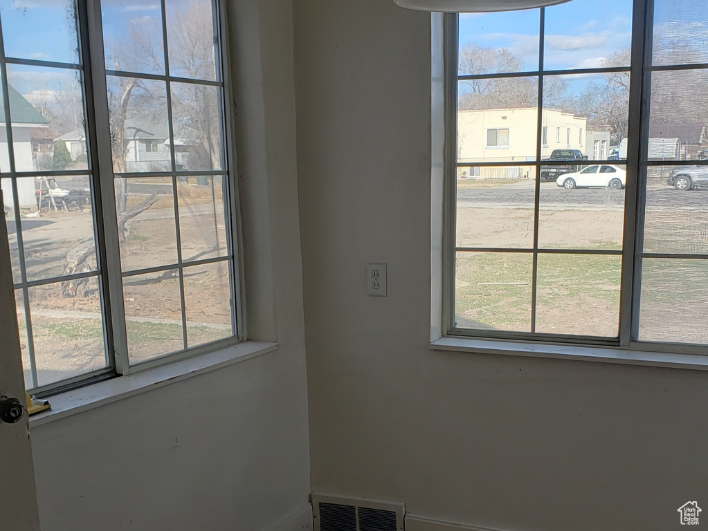 Unfurnished room featuring dark wood-type flooring, baseboards, visible vents, and vaulted ceiling