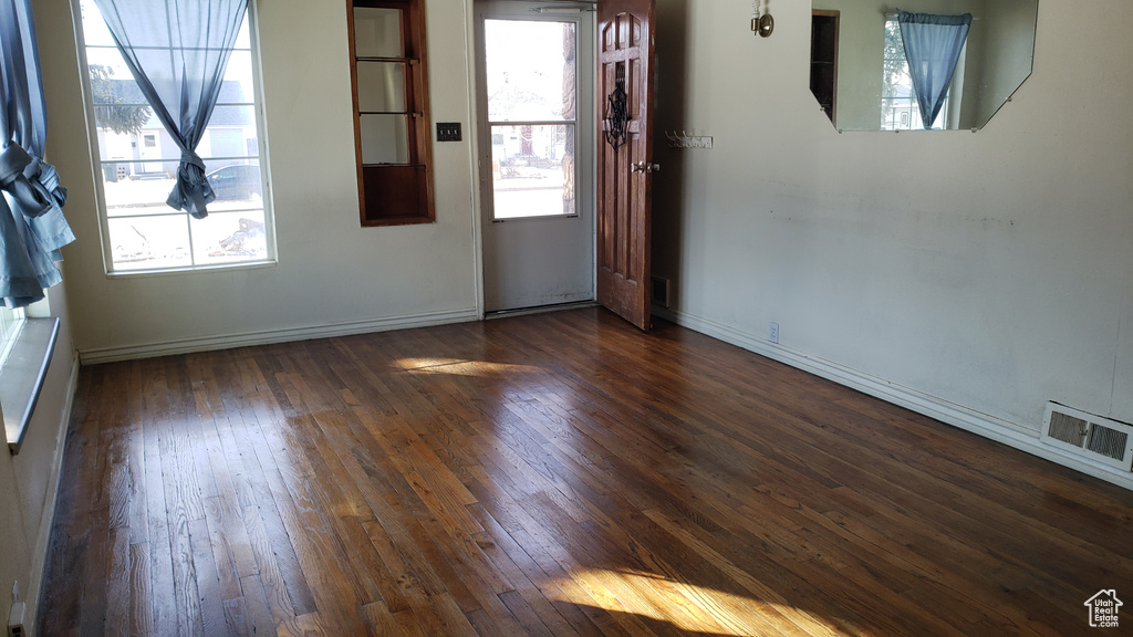 Unfurnished room featuring dark hardwood / wood-style floors