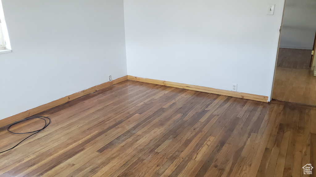 Spare room featuring wood-type flooring