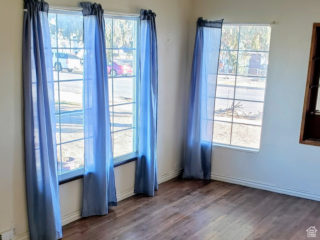 Spare room with dark wood finished floors, a textured ceiling, and baseboards