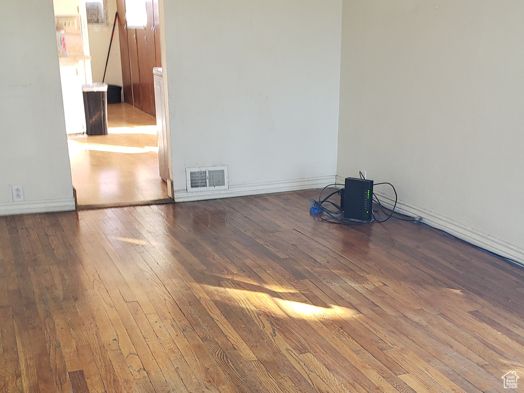 Empty room featuring hardwood / wood-style flooring