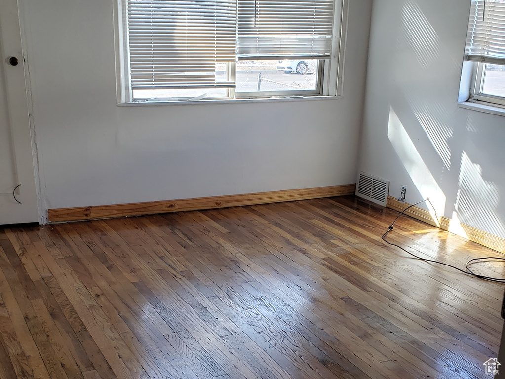 Spare room featuring dark wood-type flooring