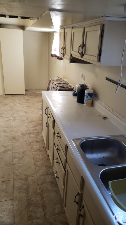 Kitchen with a sink and light countertops
