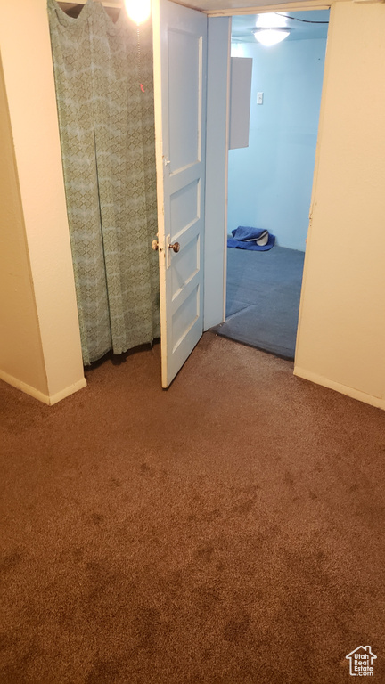 Unfurnished bedroom with carpet floors and baseboards