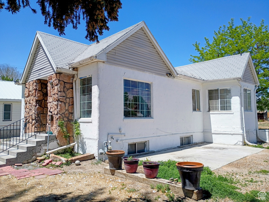View of side of property featuring a patio and stucco siding