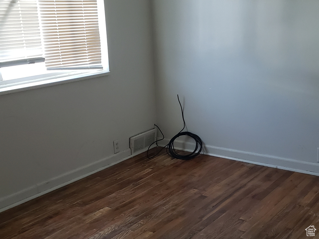 Unfurnished room with dark hardwood / wood-style floors