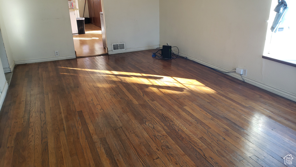 Unfurnished room with dark hardwood / wood-style floors