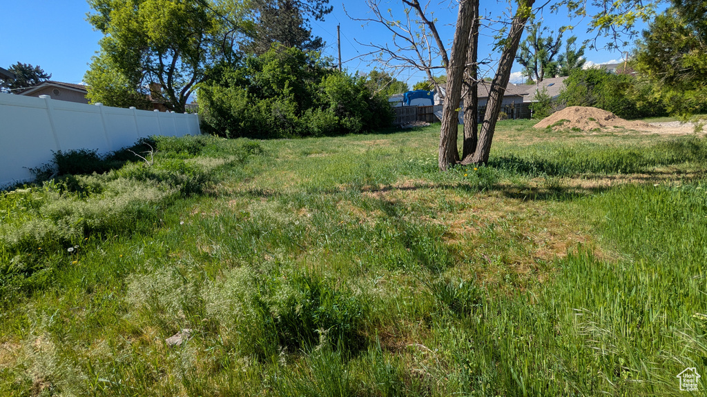View of yard featuring fence