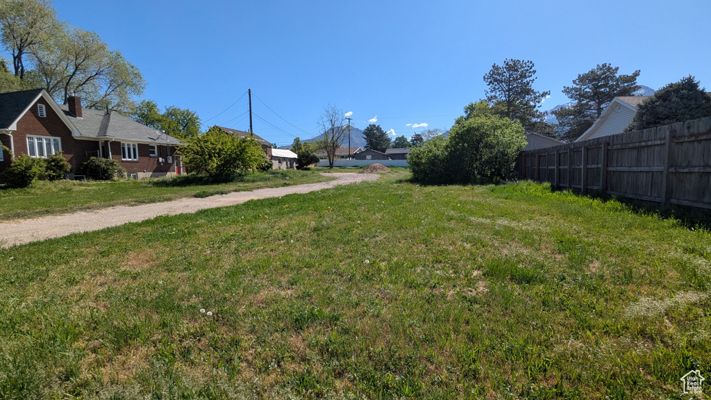 View of yard featuring fence