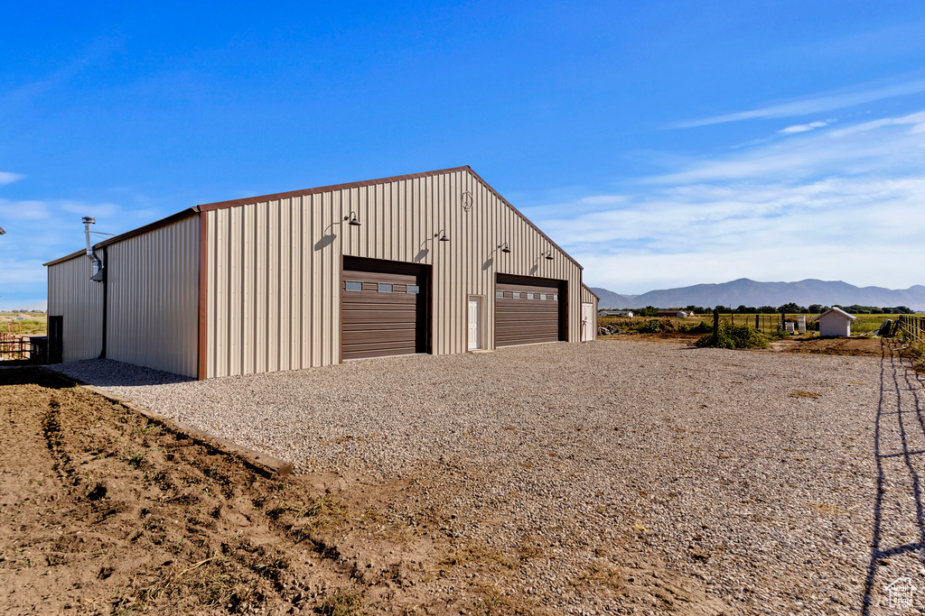 View of outbuilding with a mountain view and a garage
