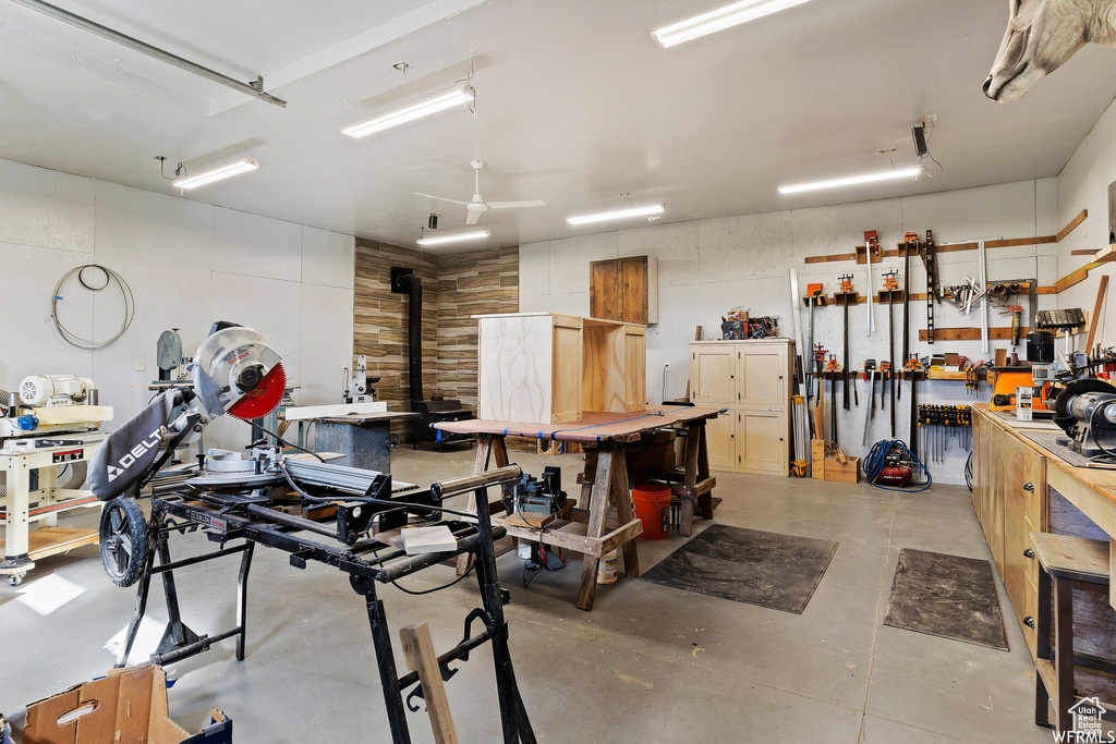 Garage featuring ceiling fan and a workshop area