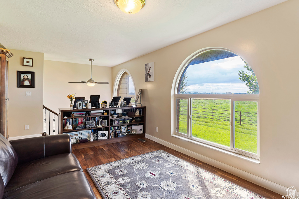 Living room featuring hardwood / wood-style flooring and ceiling fan