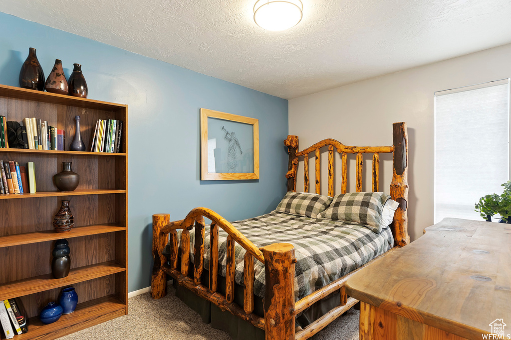 Carpeted bedroom with a textured ceiling