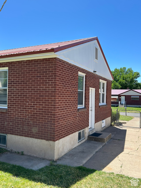 View of home\'s exterior featuring brick siding and metal roof