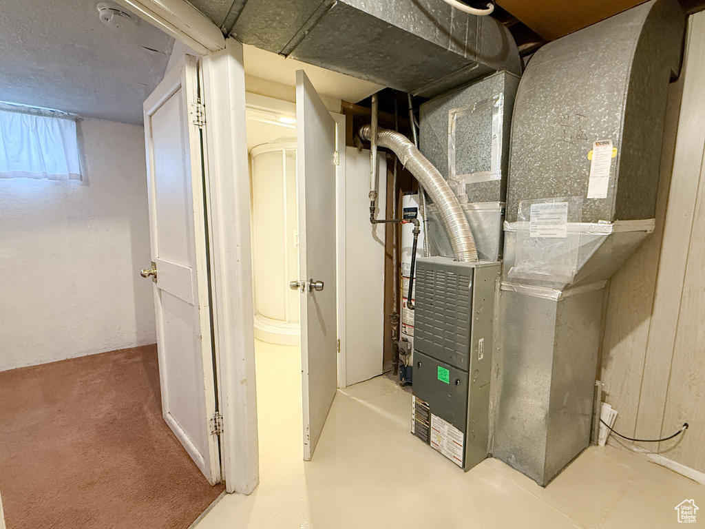 Utility room featuring heating unit