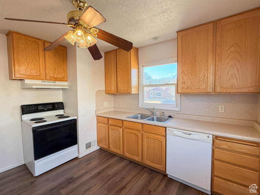 Kitchen with white dishwasher, a textured ceiling, sink, electric range, and dark wood-type flooring