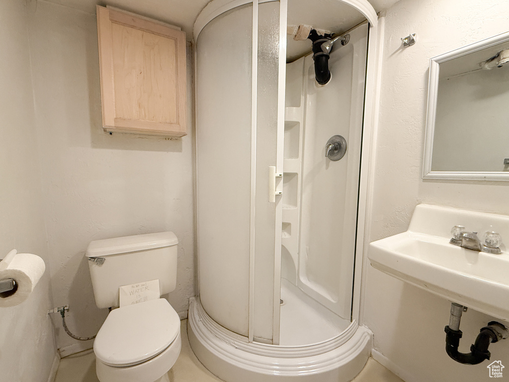 Full bathroom with toilet and a shower stall