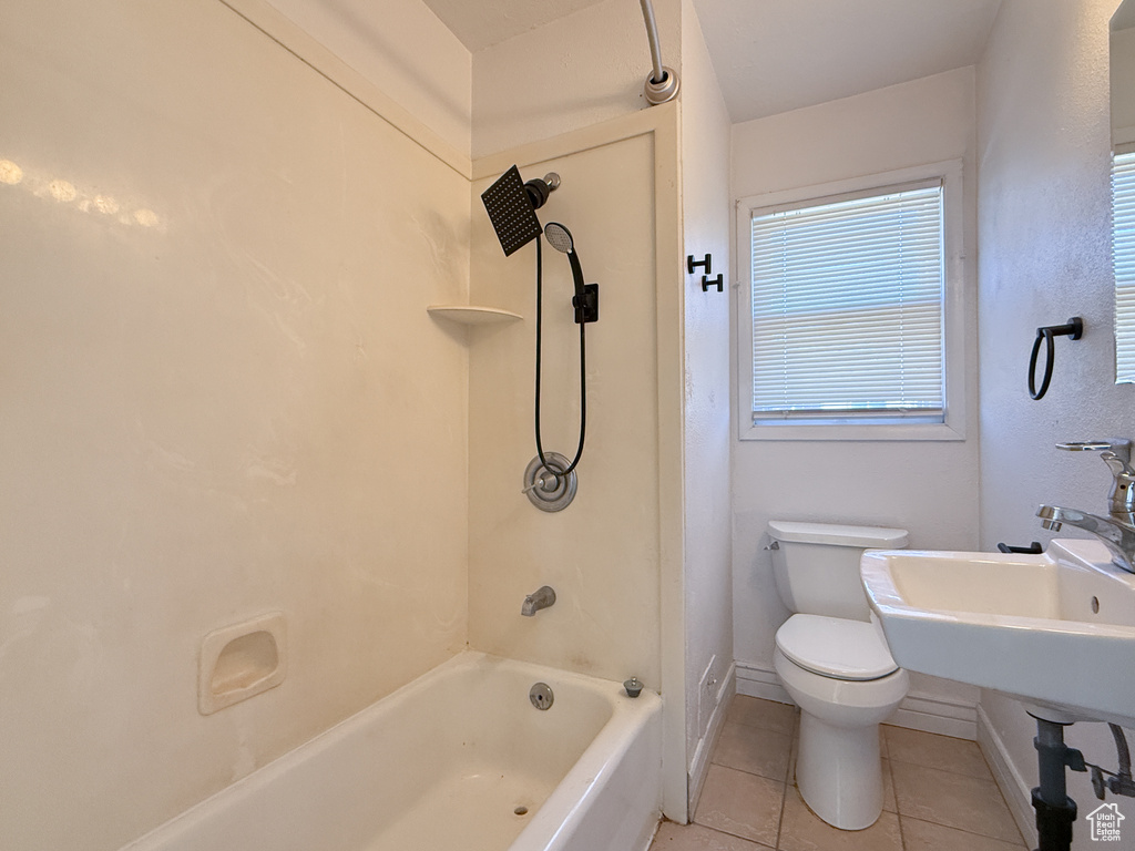 Full bathroom featuring sink, toilet, shower / bath combination, and tile patterned flooring