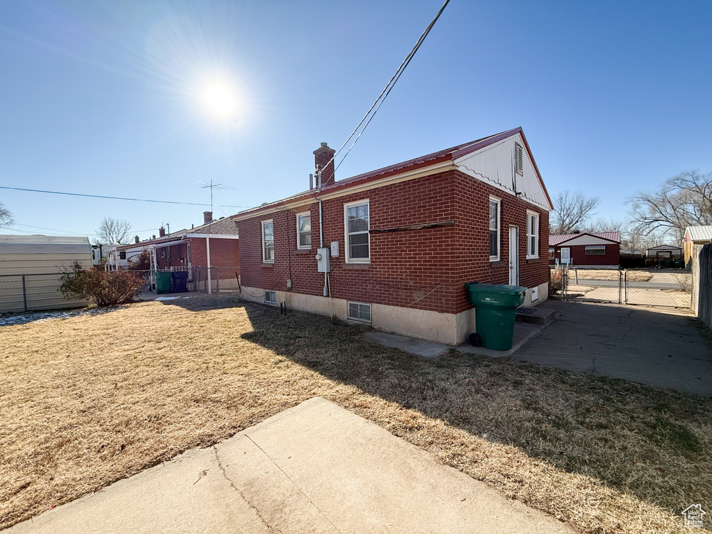 View of property exterior with a lawn