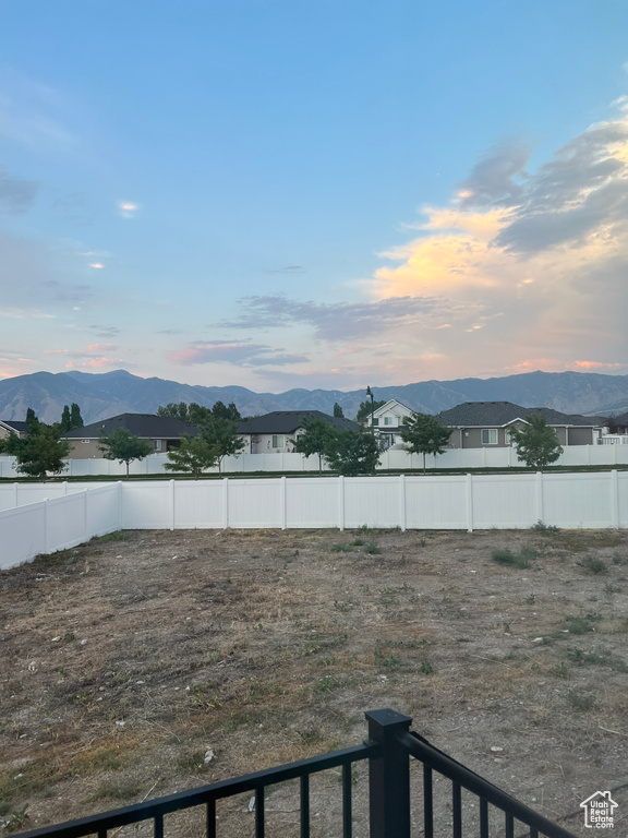 Yard at dusk featuring a mountain view