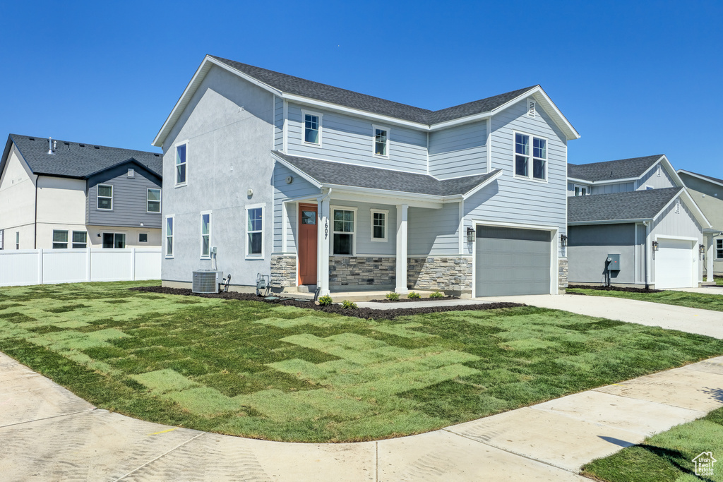 View of front facade featuring an attached garage, driveway, covered porch, stone siding, and a shingled roof