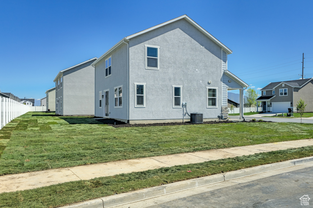 View of side of property featuring stucco siding and central AC