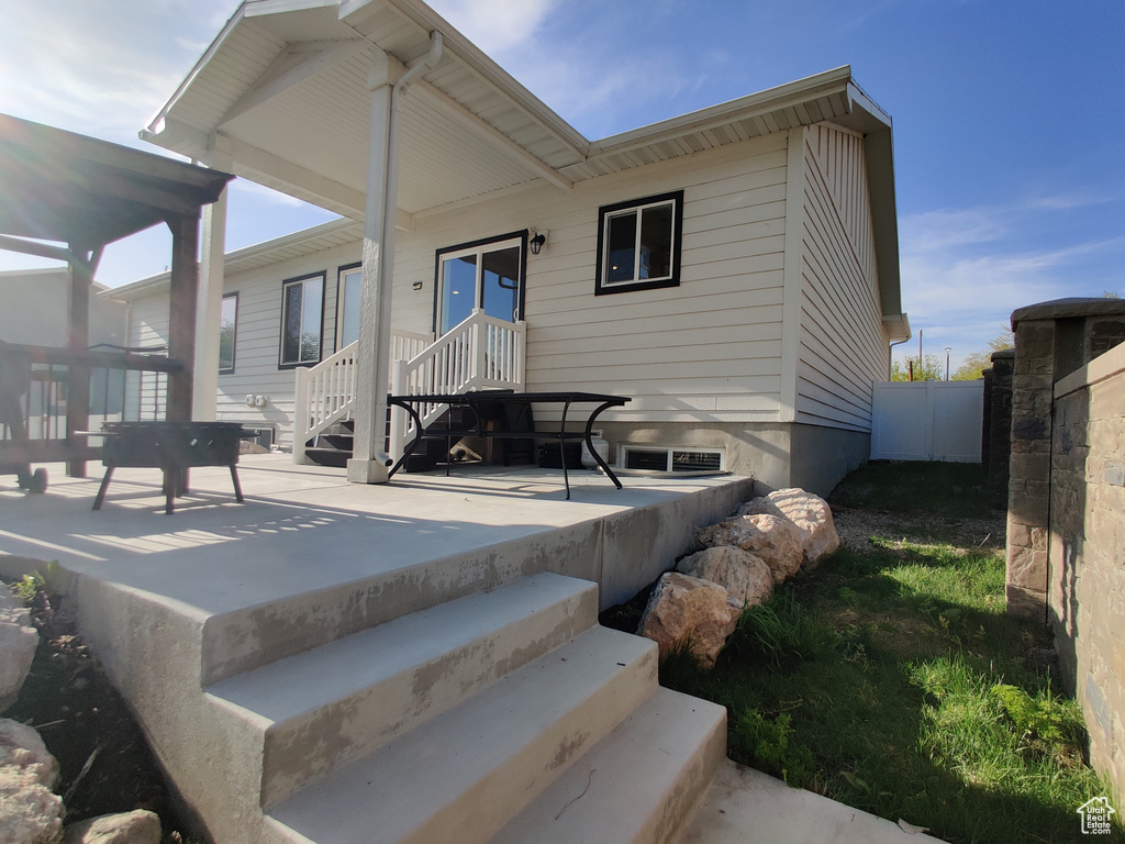 Rear view of house featuring a patio