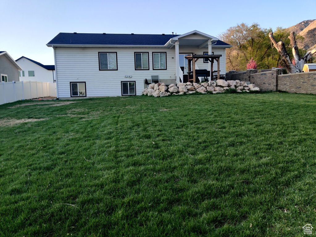 Rear view of property featuring a pergola