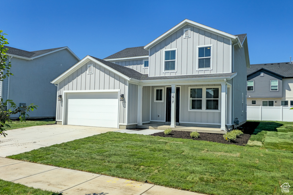 Modern farmhouse style home with board and batten siding, a porch, a garage, driveway, and a shingled roof