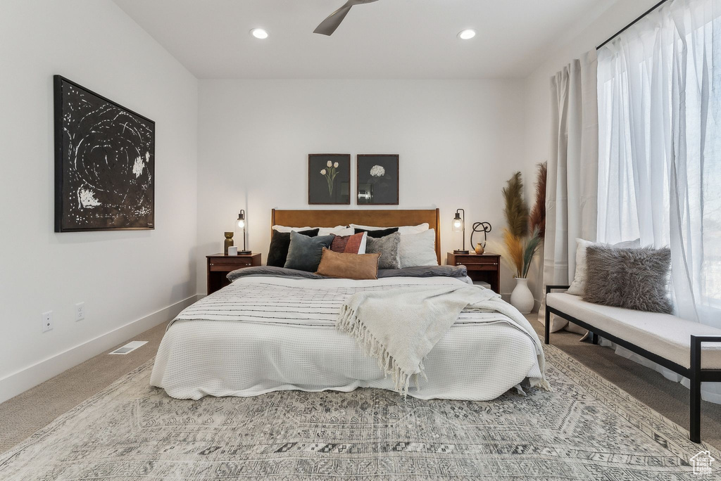 Bedroom featuring ceiling fan and carpet