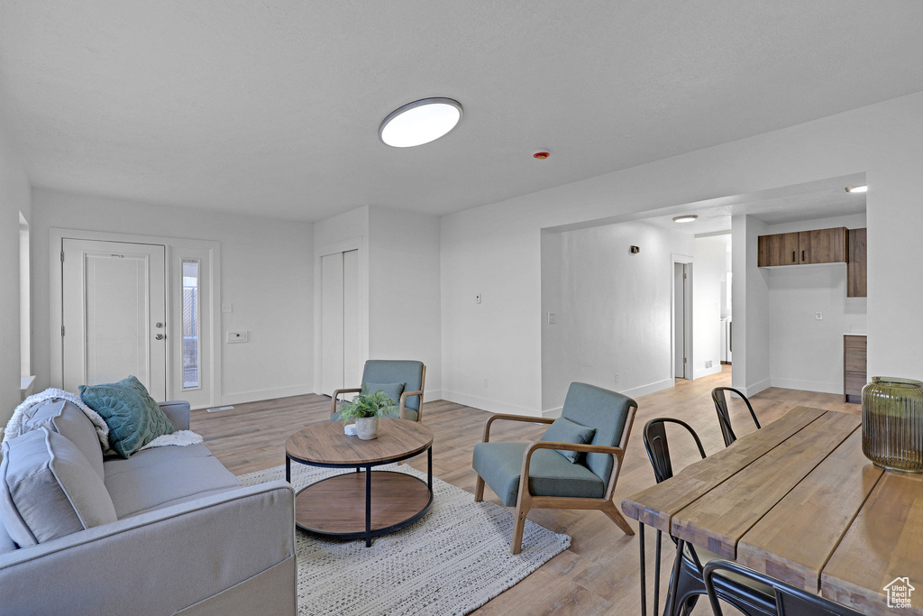 Living room with light hardwood / wood-style flooring