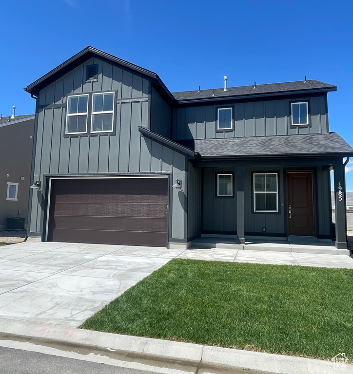 View of front of house with covered porch, a shingled roof, board and batten siding, concrete driveway, and an attached garage