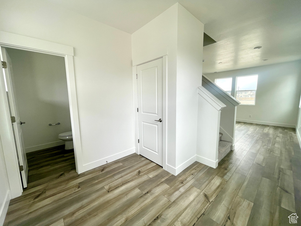 Bonus room with baseboards and wood finished floors