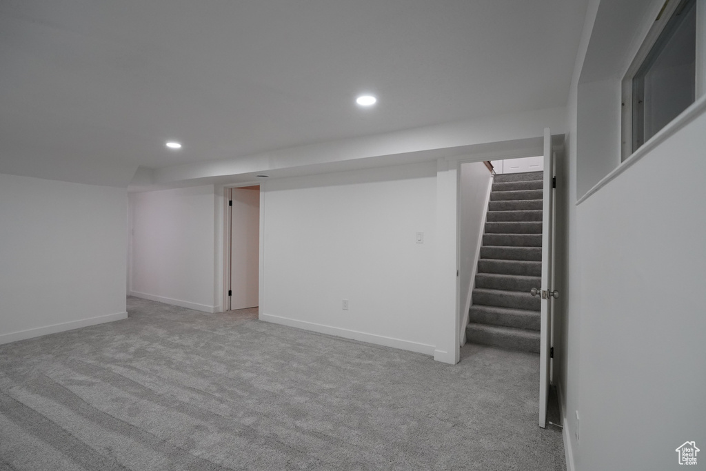 Basement with light colored carpet