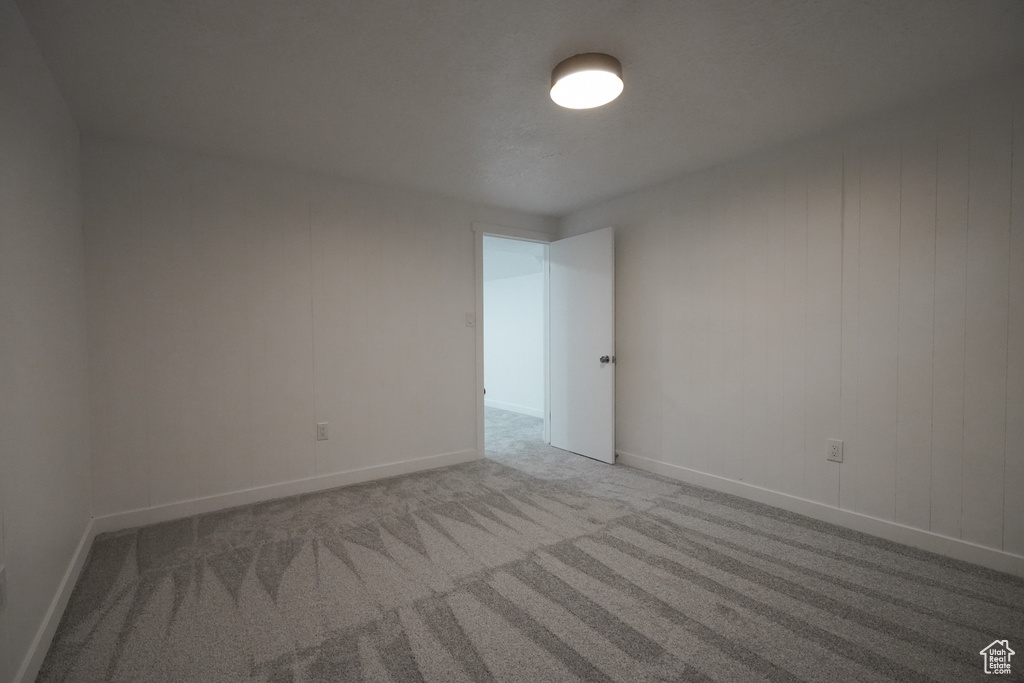 Unfurnished room featuring light colored carpet