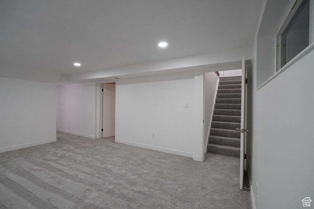 Basement featuring light colored carpet