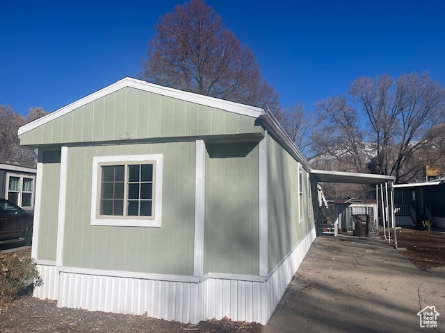 View of property exterior featuring a carport