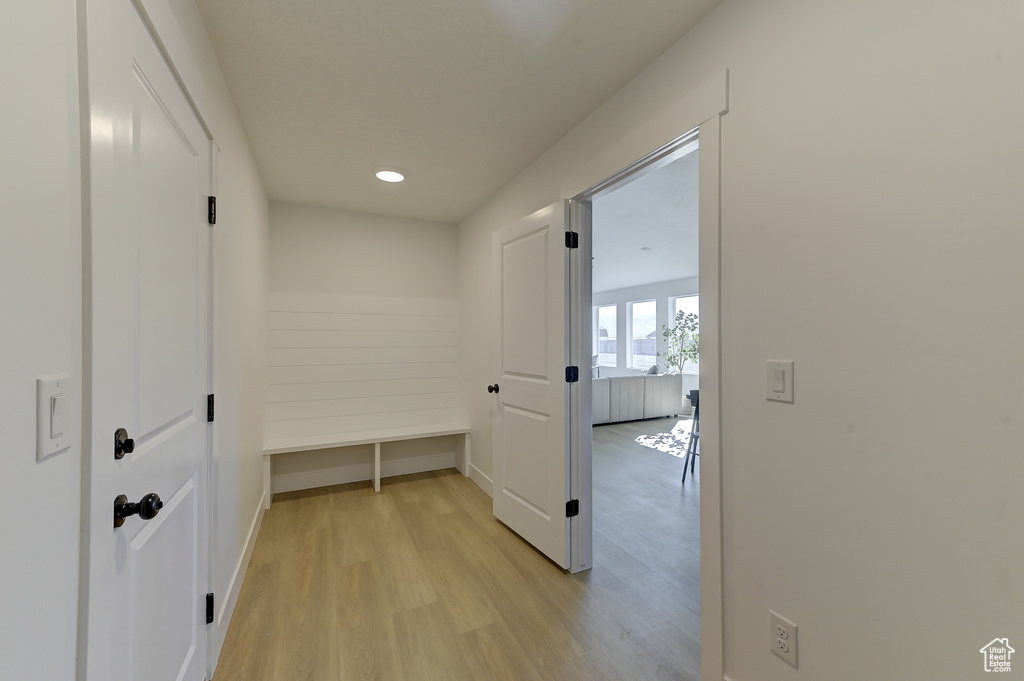 Corridor with light hardwood / wood-style flooring