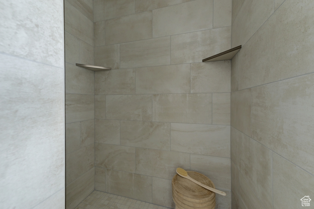 Interior details featuring a tile shower